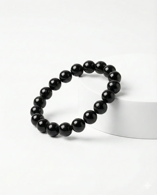 Natural Black Obsidian beaded bracelet featuring shiny 8mm black stones on white background.