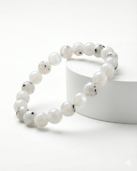 Natural Rainbow Moonstone beaded bracelet featuring 8mm white stones with black tourmaline inclusions on white background.