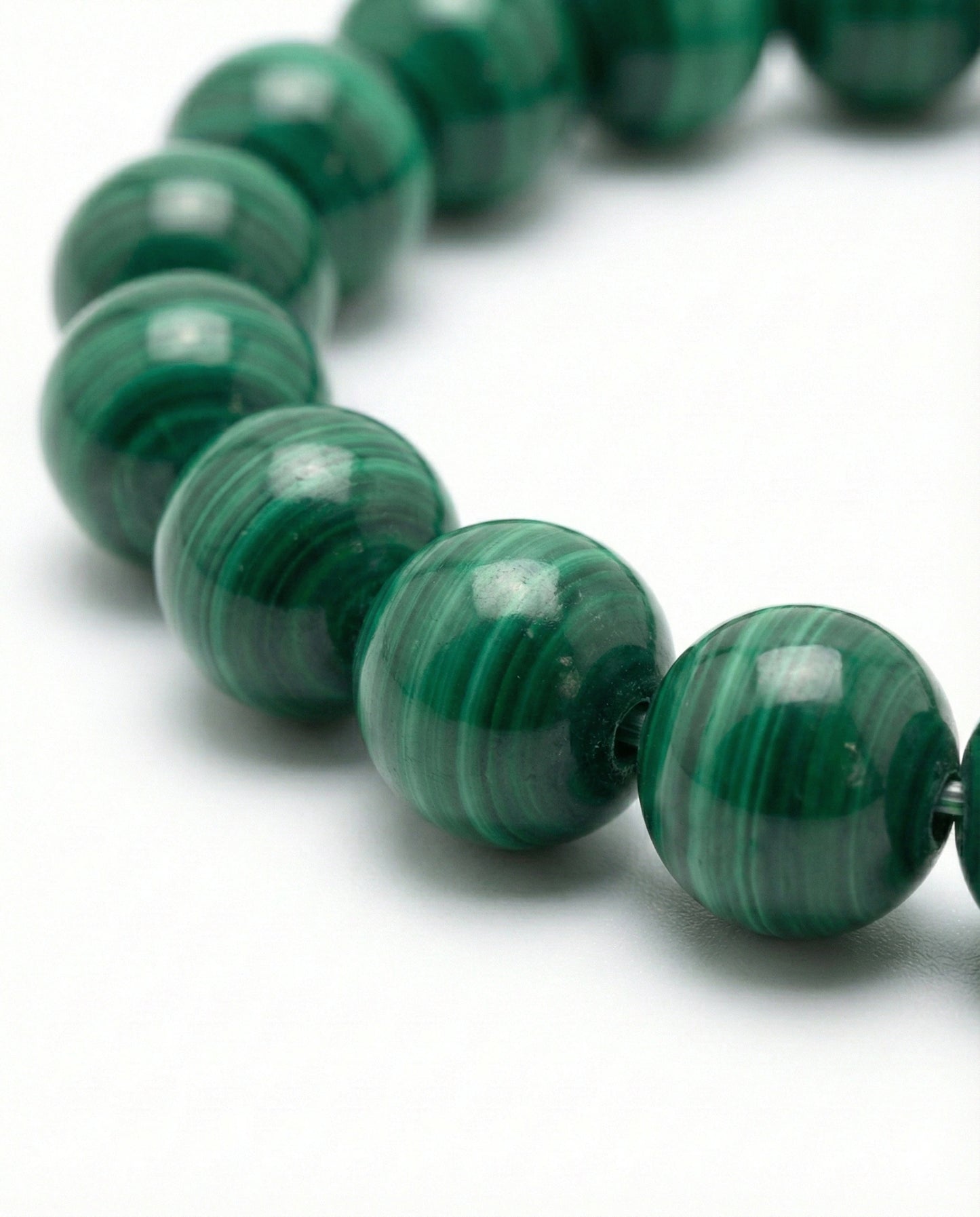 Natural Malachite beaded bracelet featuring 8mm green banded stones on white background.