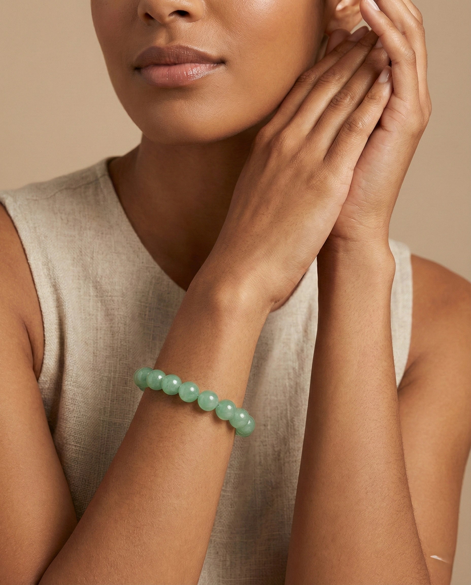 Natural Green Aventurine beaded bracelet featuring 8mm light green translucent stones on white background.