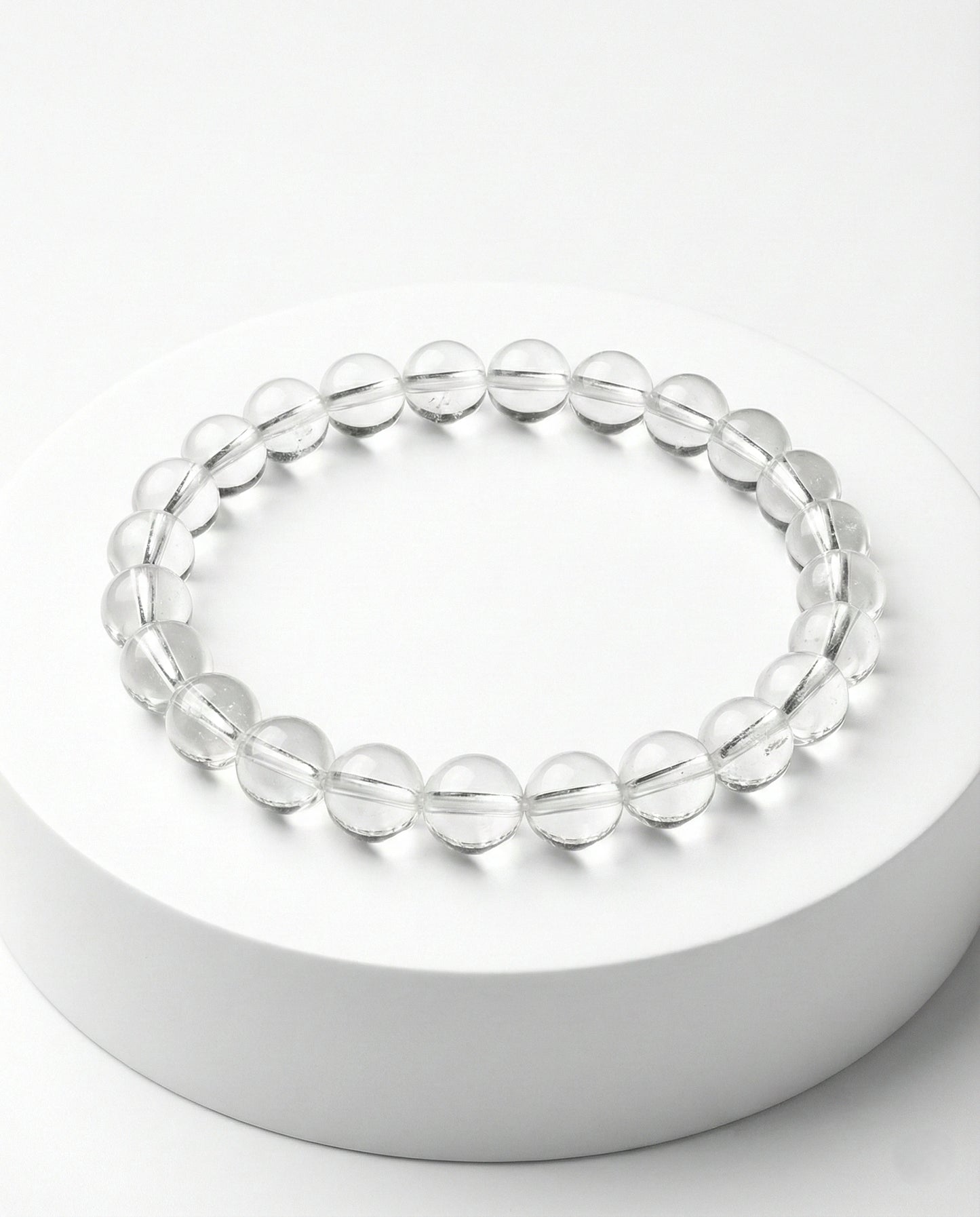 Natural Clear Quartz beaded bracelet with transparent round gemstones on black background.