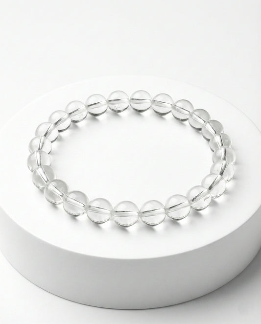 Natural Clear Quartz beaded bracelet with transparent round gemstones on black background.