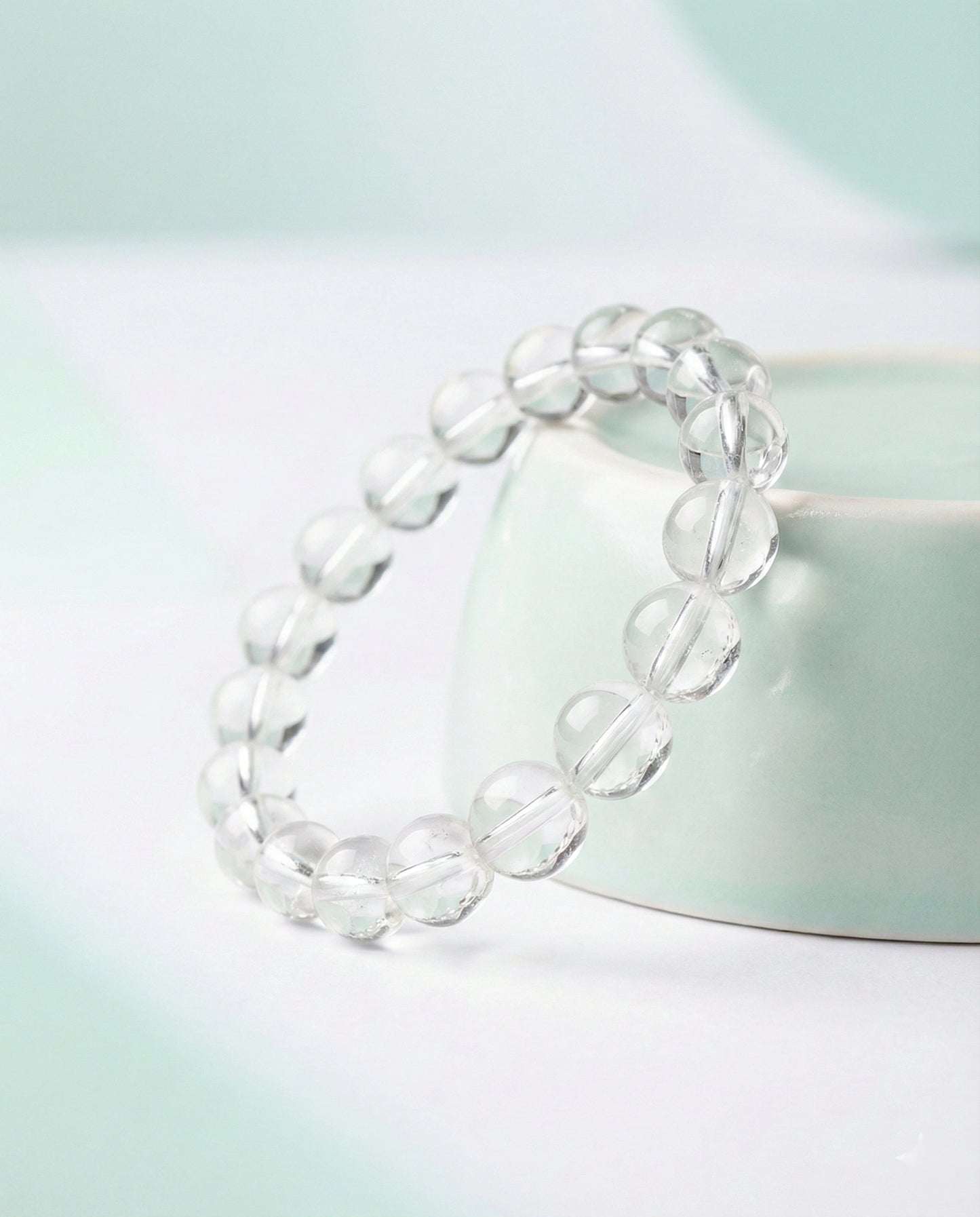 Natural Clear Quartz beaded bracelet with transparent round gemstones on black background.