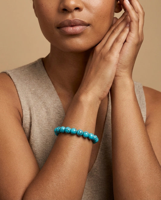 Natural Turquoise beaded bracelet featuring 8mm blue stones with black veining on white background.