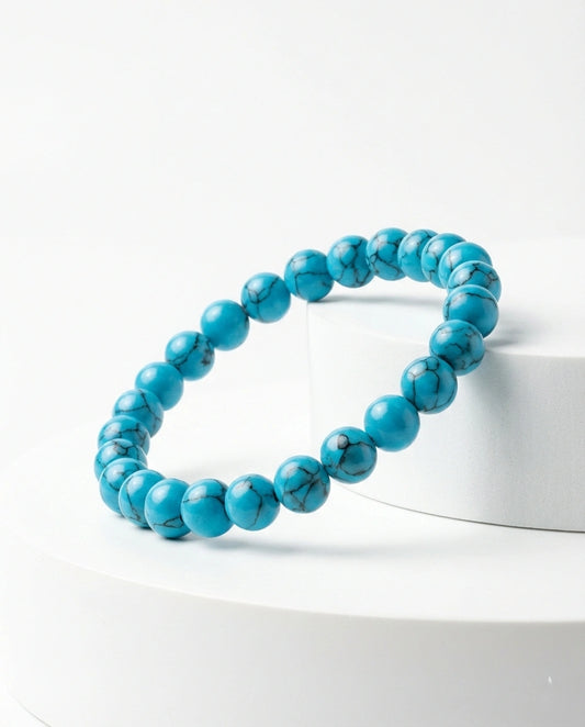 Natural Turquoise beaded bracelet featuring 8mm blue stones with black veining on white background.