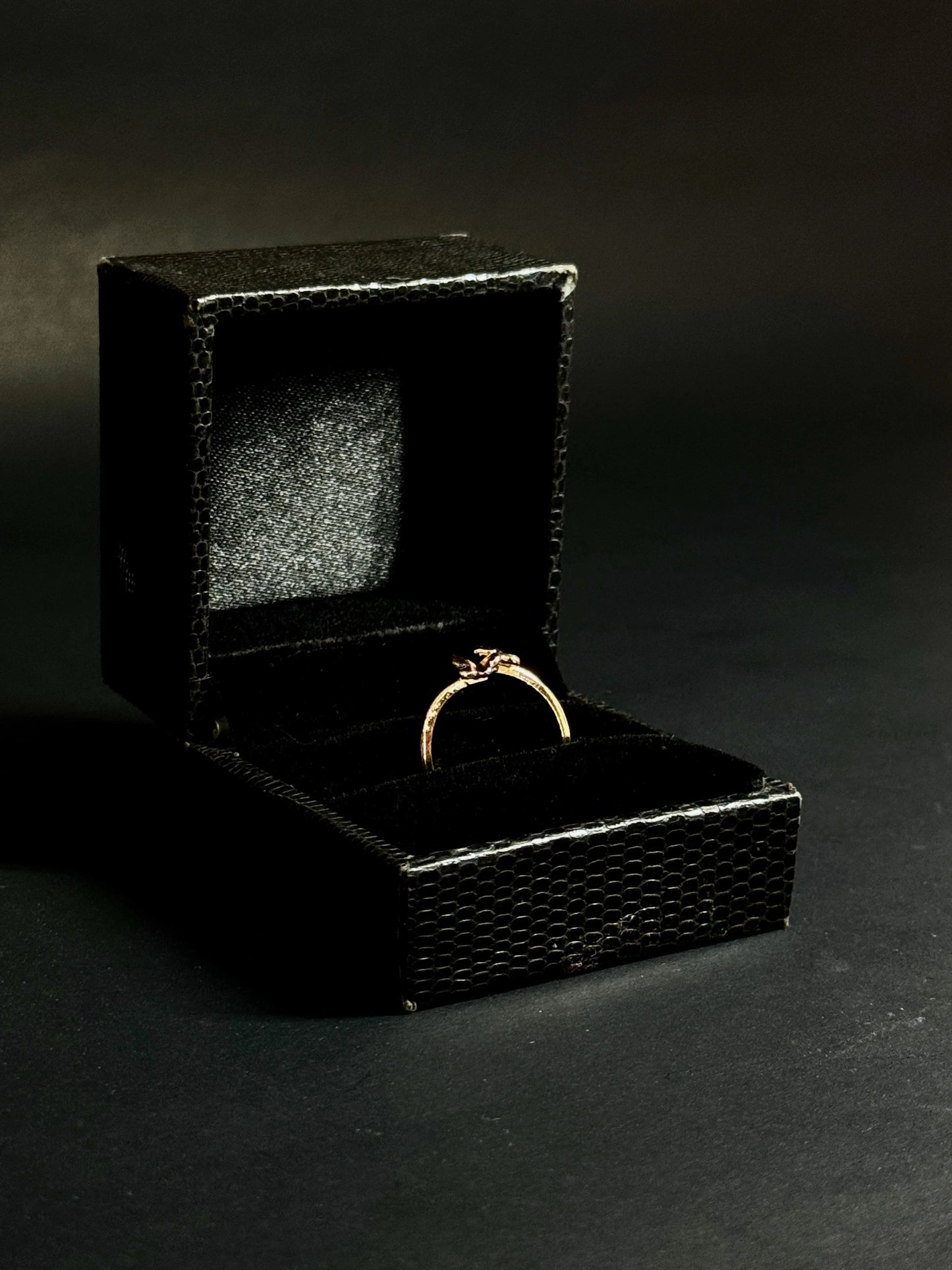 Rose Gold vermeil ring featuring two small butterflies on a dainty band on black background.