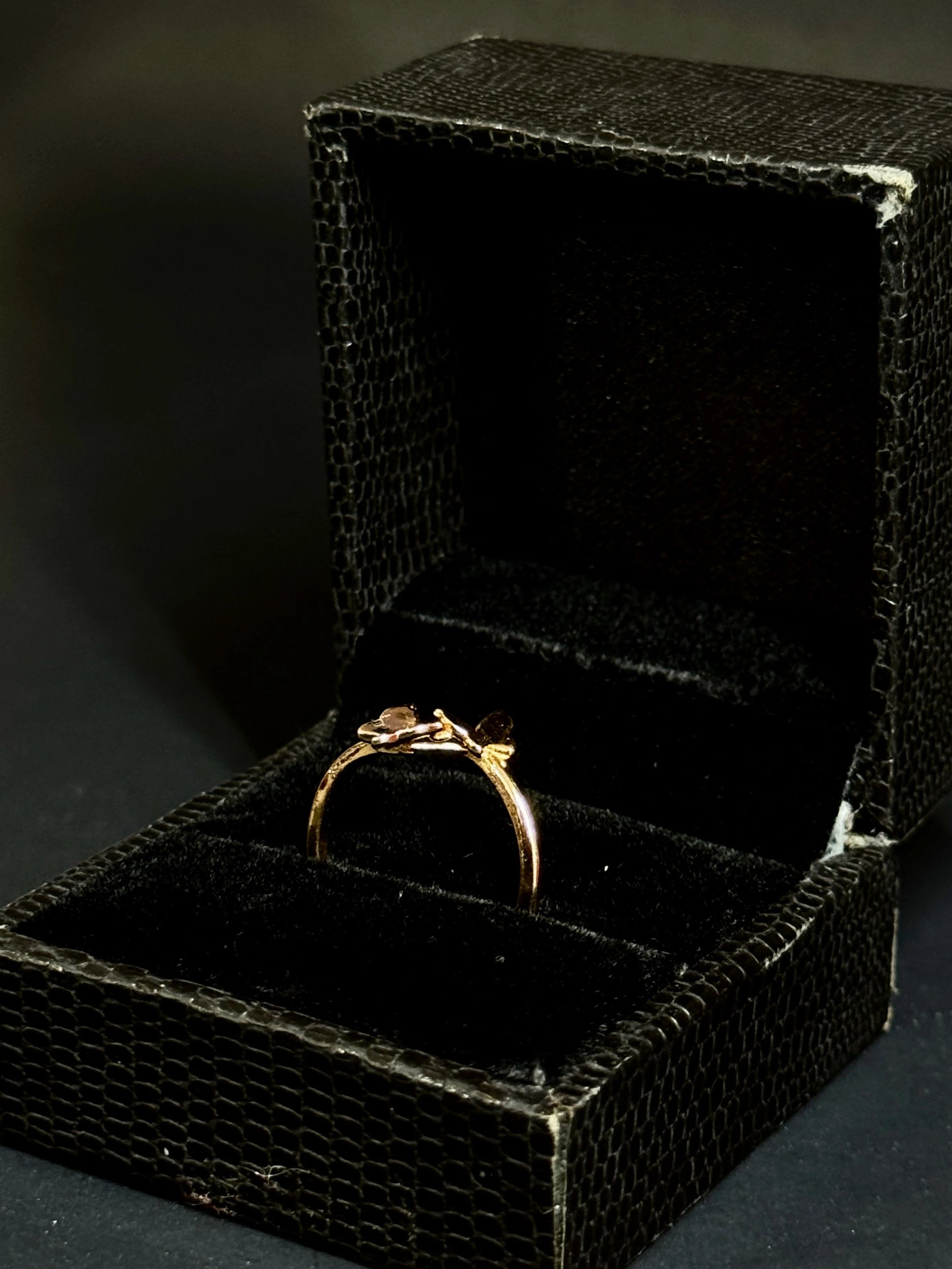 Rose Gold vermeil ring featuring two small butterflies on a dainty band on black background.