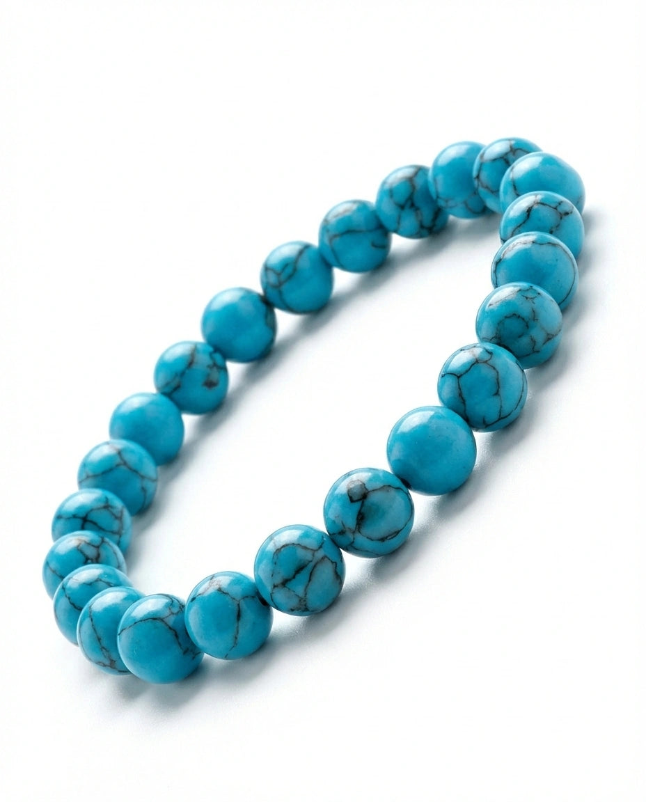 Natural Turquoise beaded bracelet featuring 8mm blue stones with black veining on white background.