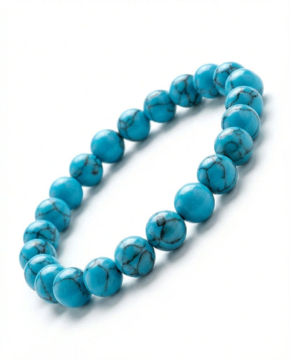 Natural Turquoise beaded bracelet featuring 8mm blue stones with black veining on white background.