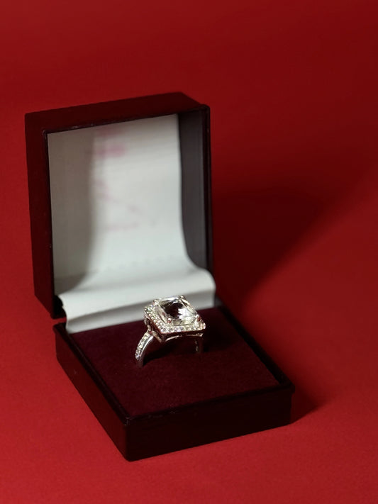 Large rectangular Clear Quartz gemstone ring with halo setting in 925 sterling silver on black background