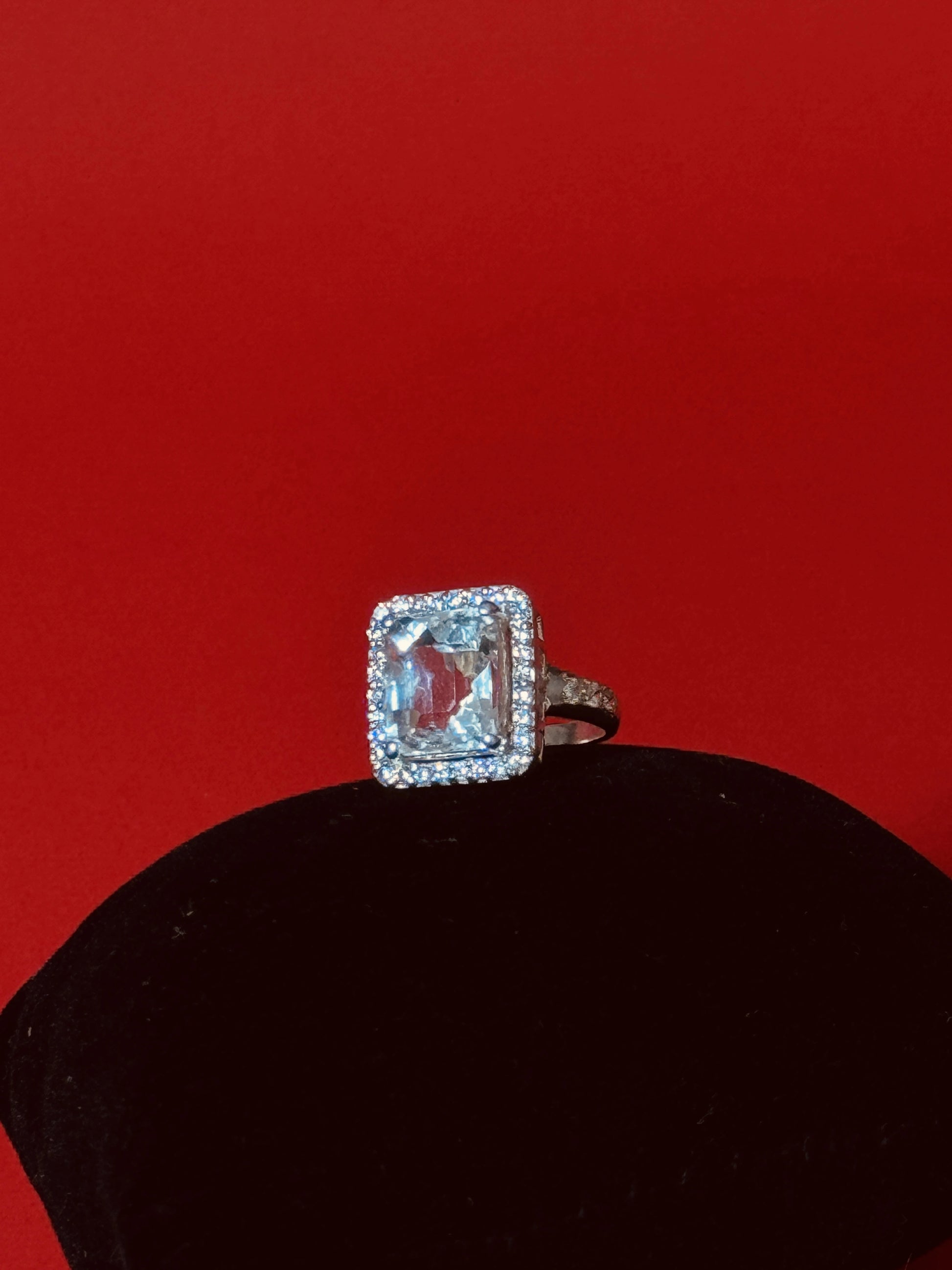 Large rectangular Clear Quartz gemstone ring with halo setting in 925 sterling silver on black background